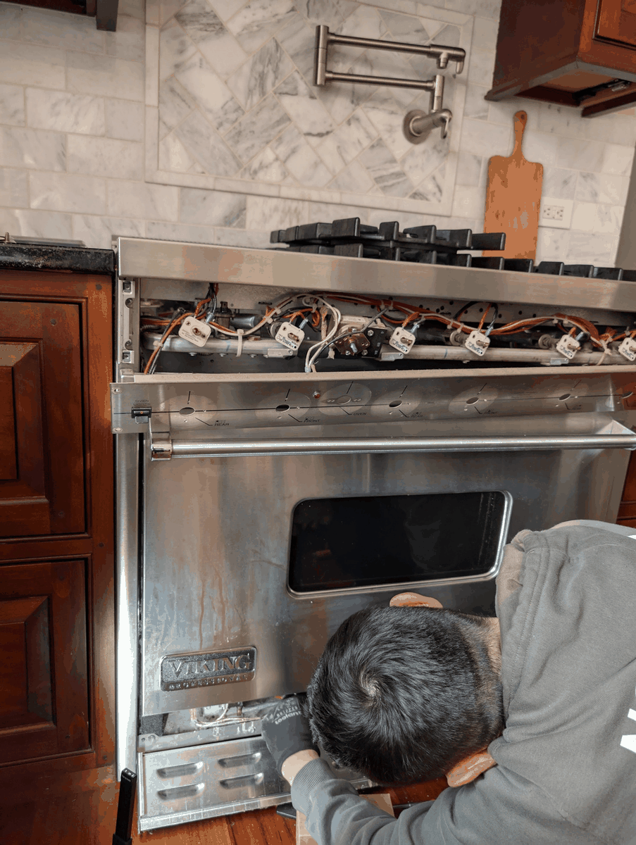 Repairing a gas oven burner in South Philadelphia by replacing a worn glow bar igniter on a Frigidaire stove